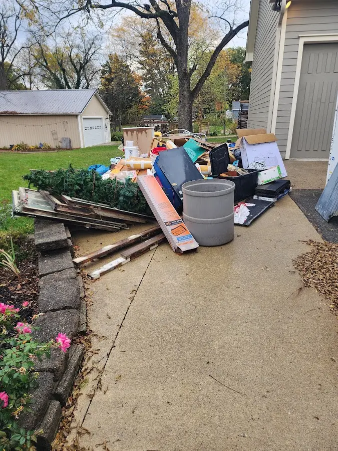 Dumpster being loaded with debris for Demolition Dumpster Rental in East St. Louis
